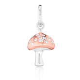 A sterling silver charm shaped like a mushroom with the top part coated in rose gold, featuring clear stone accents.